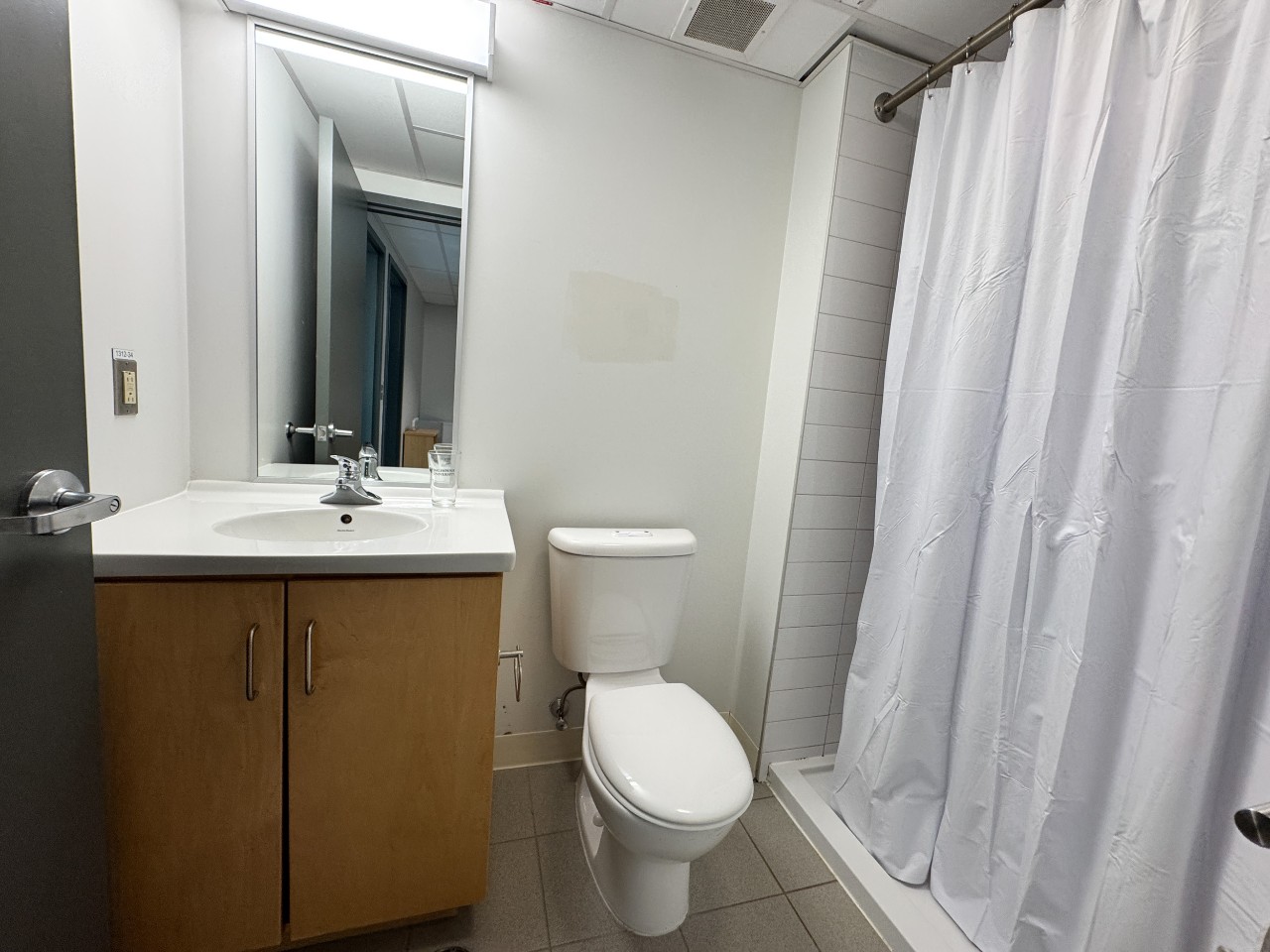 The bathroom in a 2-bedroom suite in LeMarchant Place with toilet, shower and sink
