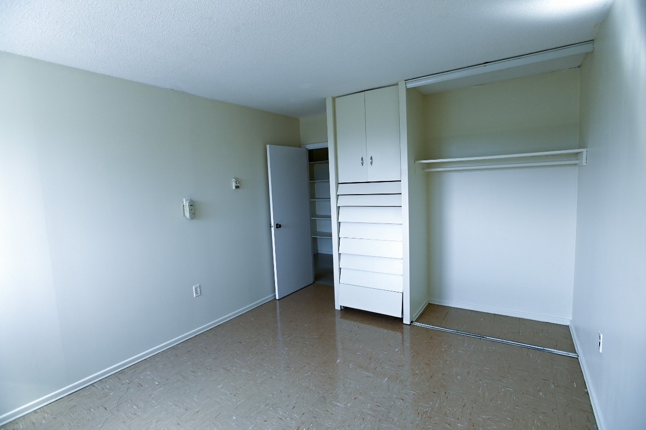 The second bedroom in a two-bedroom unit with a large built-in closet