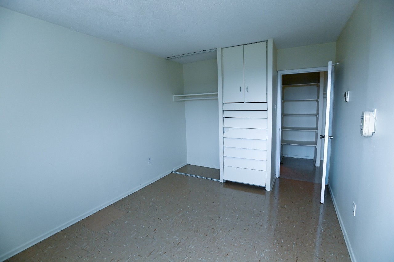 The first bedroom in a two-bedroom unit with a large built-in closet