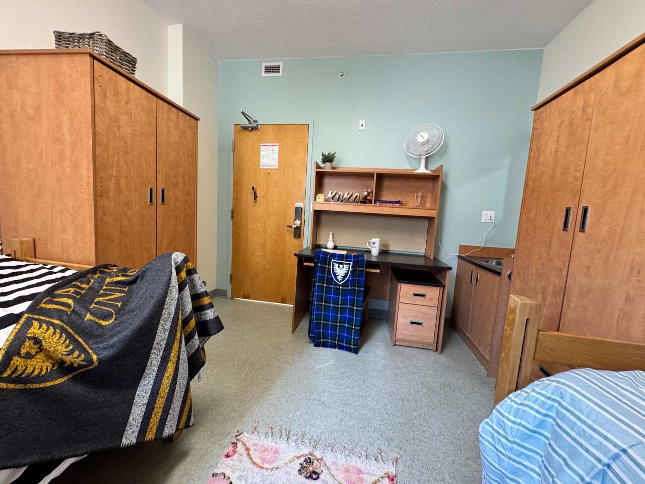 A double room in Risley Hall, with 2 adjustable beds, two desks, two wardrobes, and storage drawers.