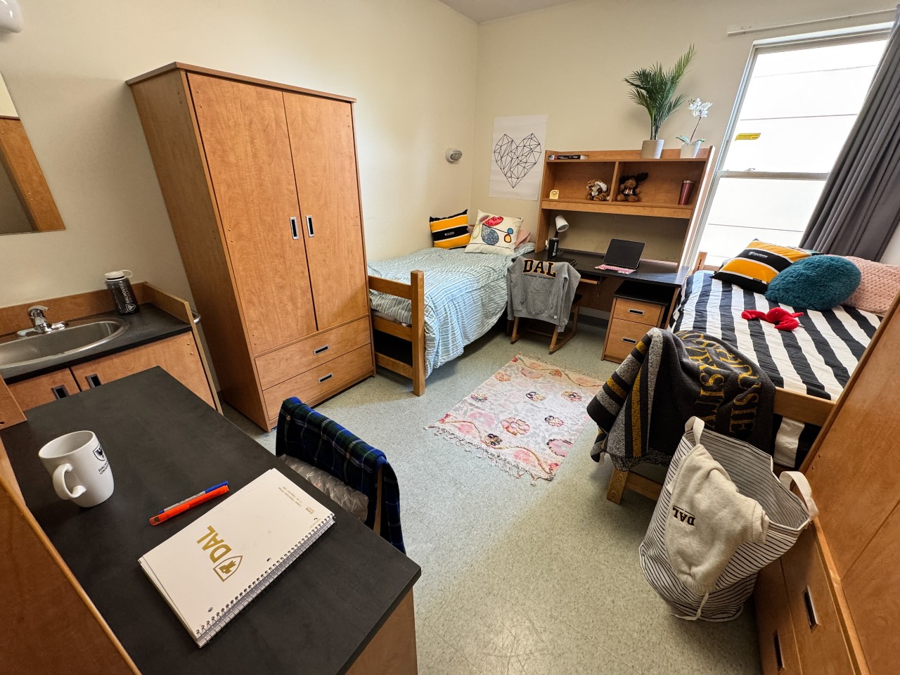 A double room in Risley Hall, with 2 adjustable beds, two desks, two wardrobes, and storage drawers.