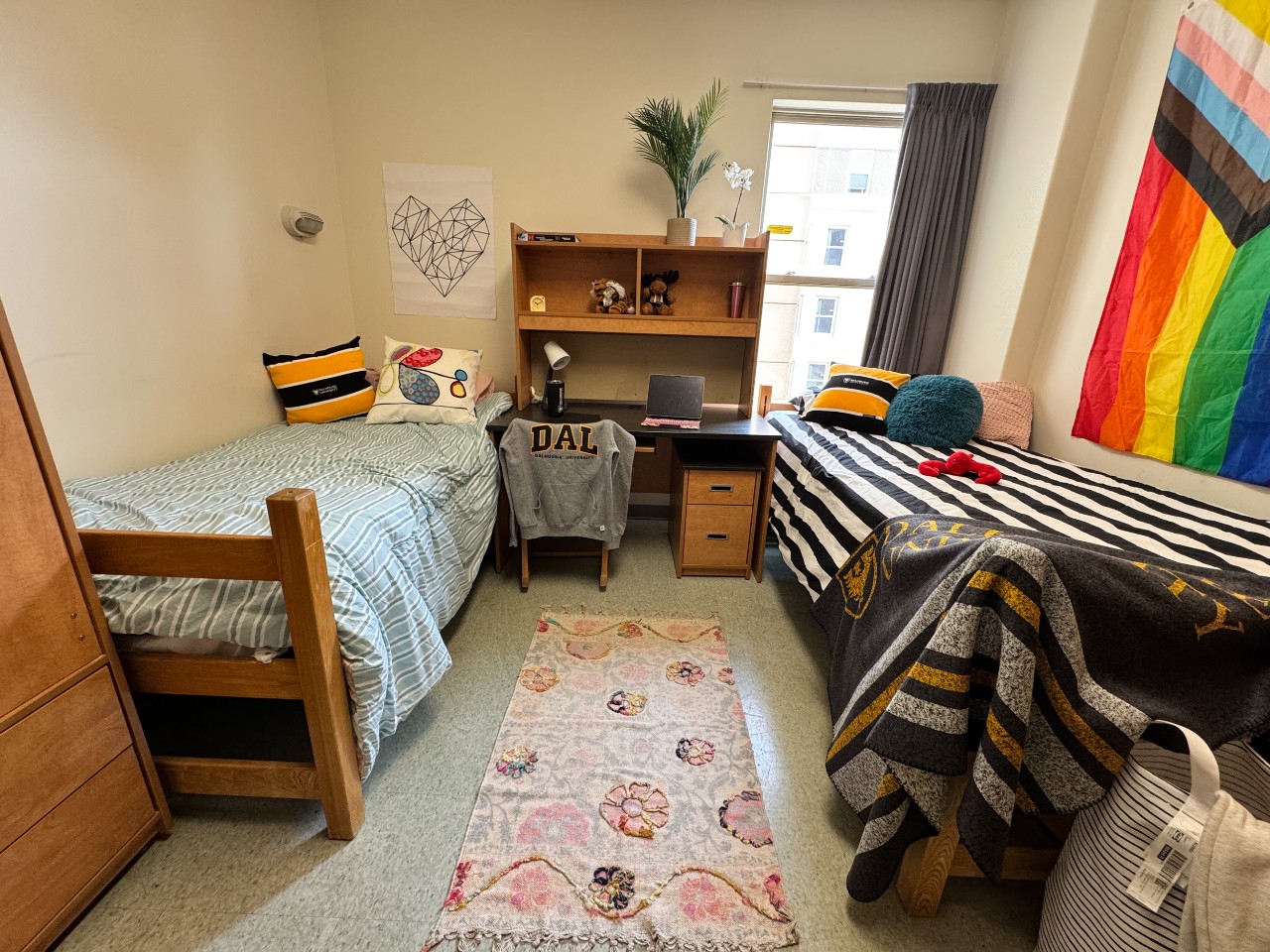 A double room in Risley Hall, with 2 adjustable beds, two desks, two wardrobes, and storage drawers.