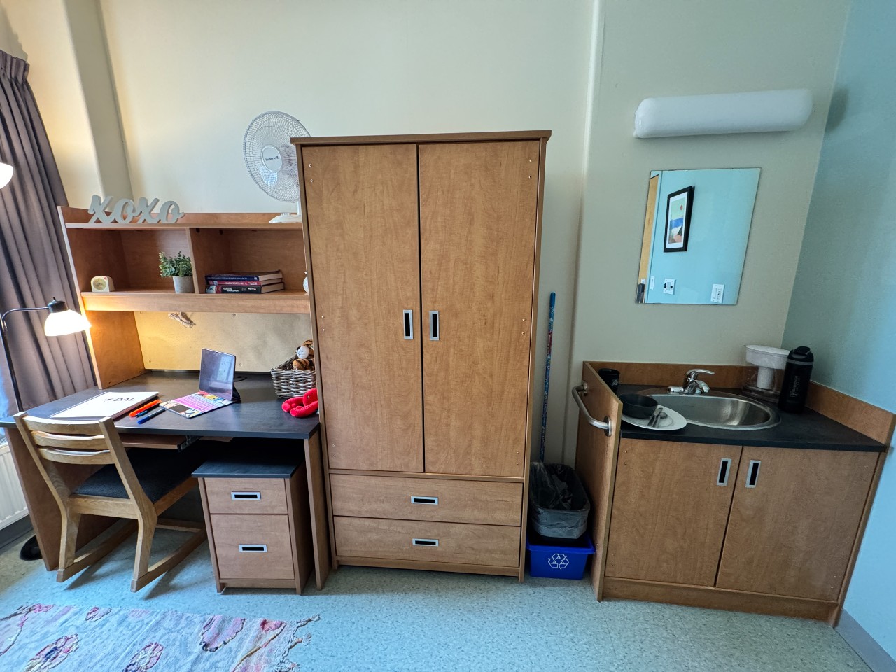 The desk, wardrobe, and sink inside a single room in Risley Hall.