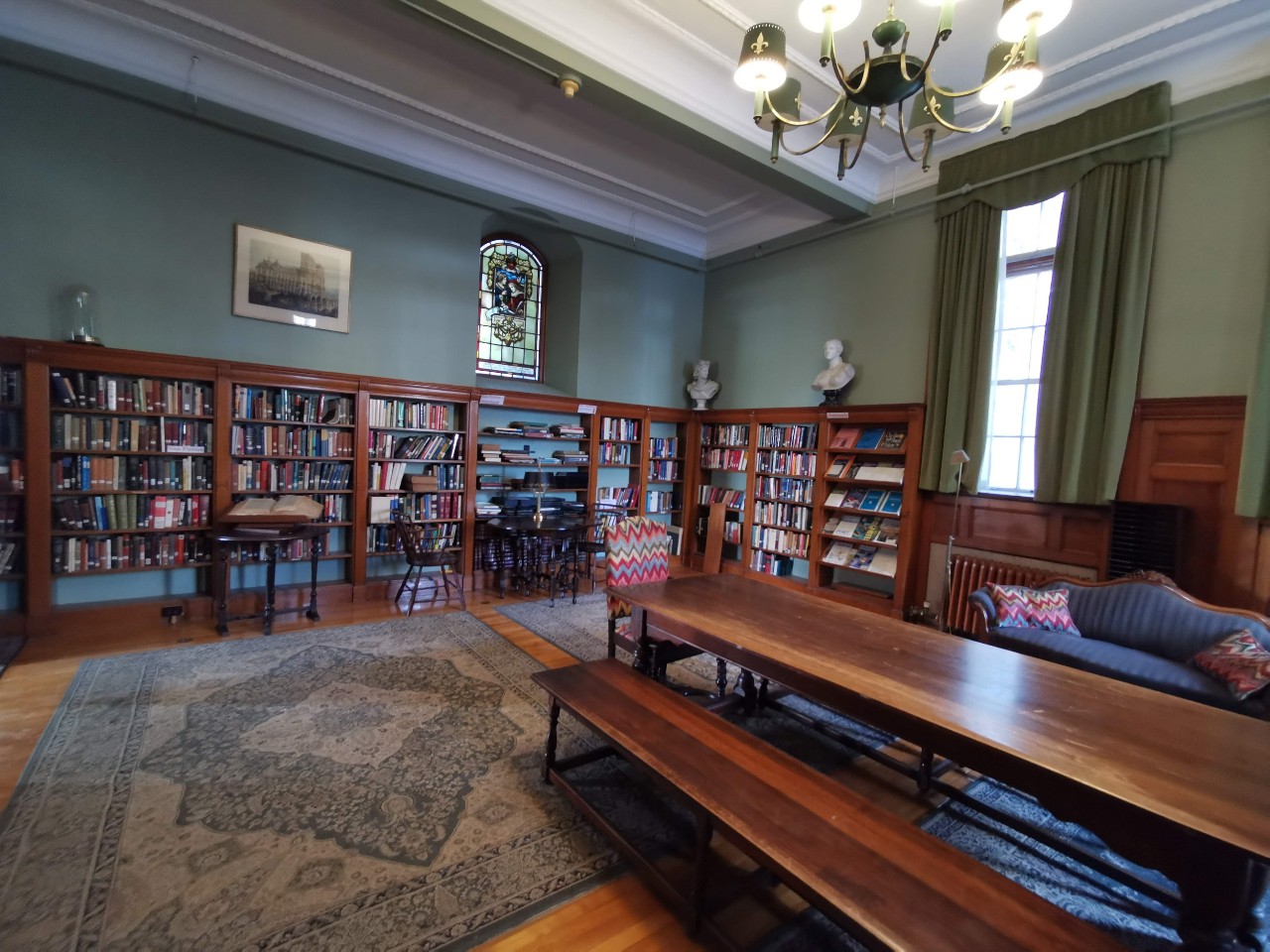 The Library in Shirreff Hall is an ornate space, with many old books, classical furniture, and a long reading table.