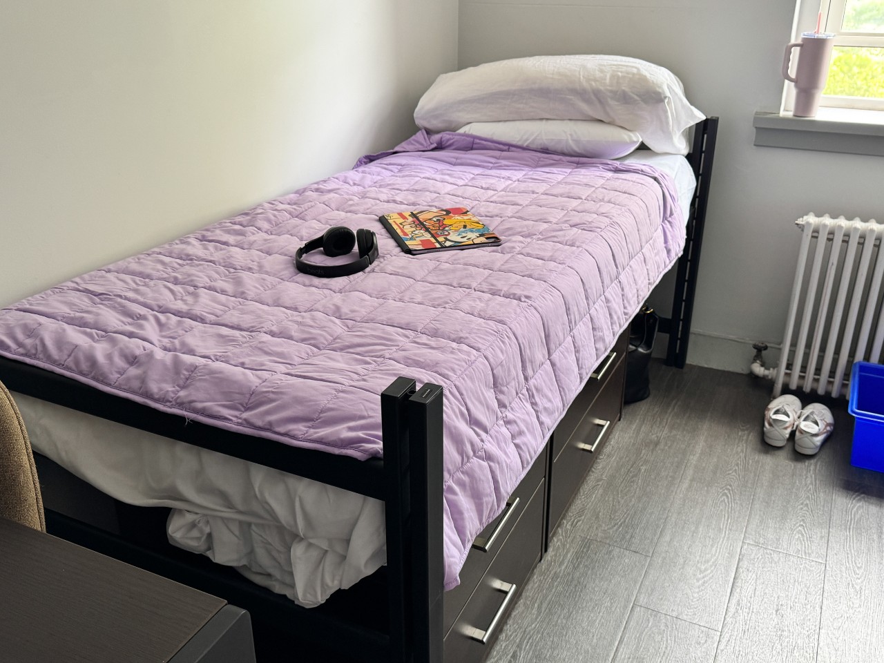 A photo of a bed in a double room in Trueman House with storage drawers underneath