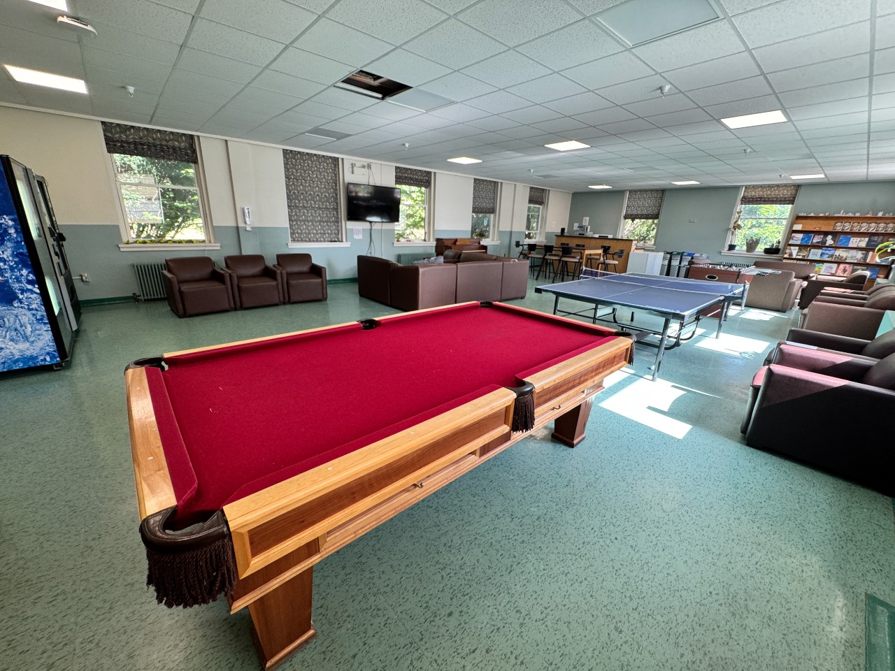 The pool table in the Trueman House lounge, covered in red felt.