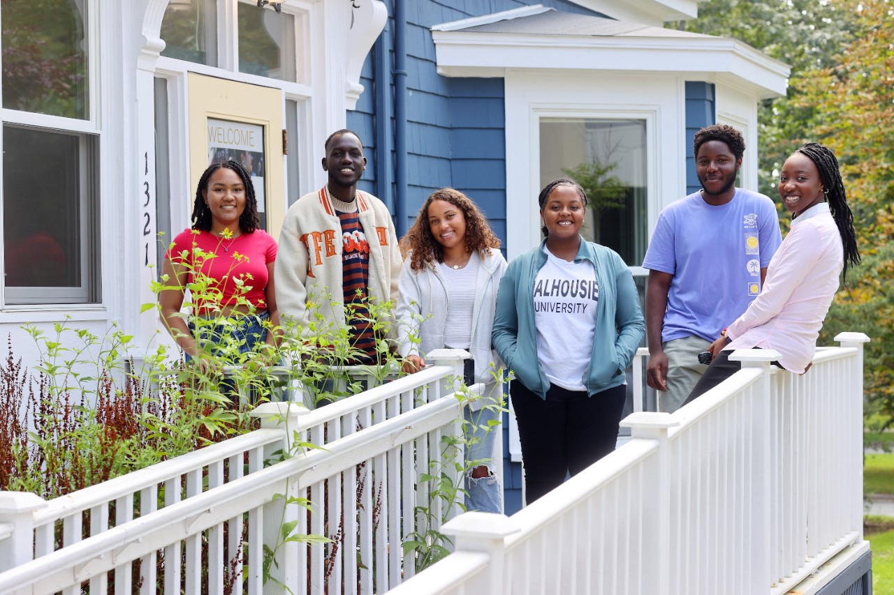 A group of students stand in front of the Black Student Advising Centre.