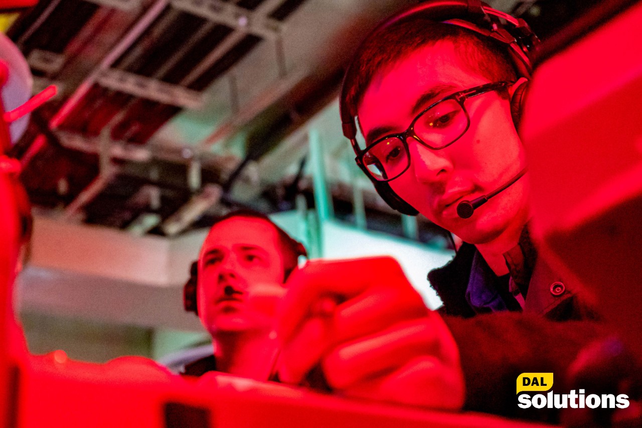 Technician wears a headphone at his work and shine by red light