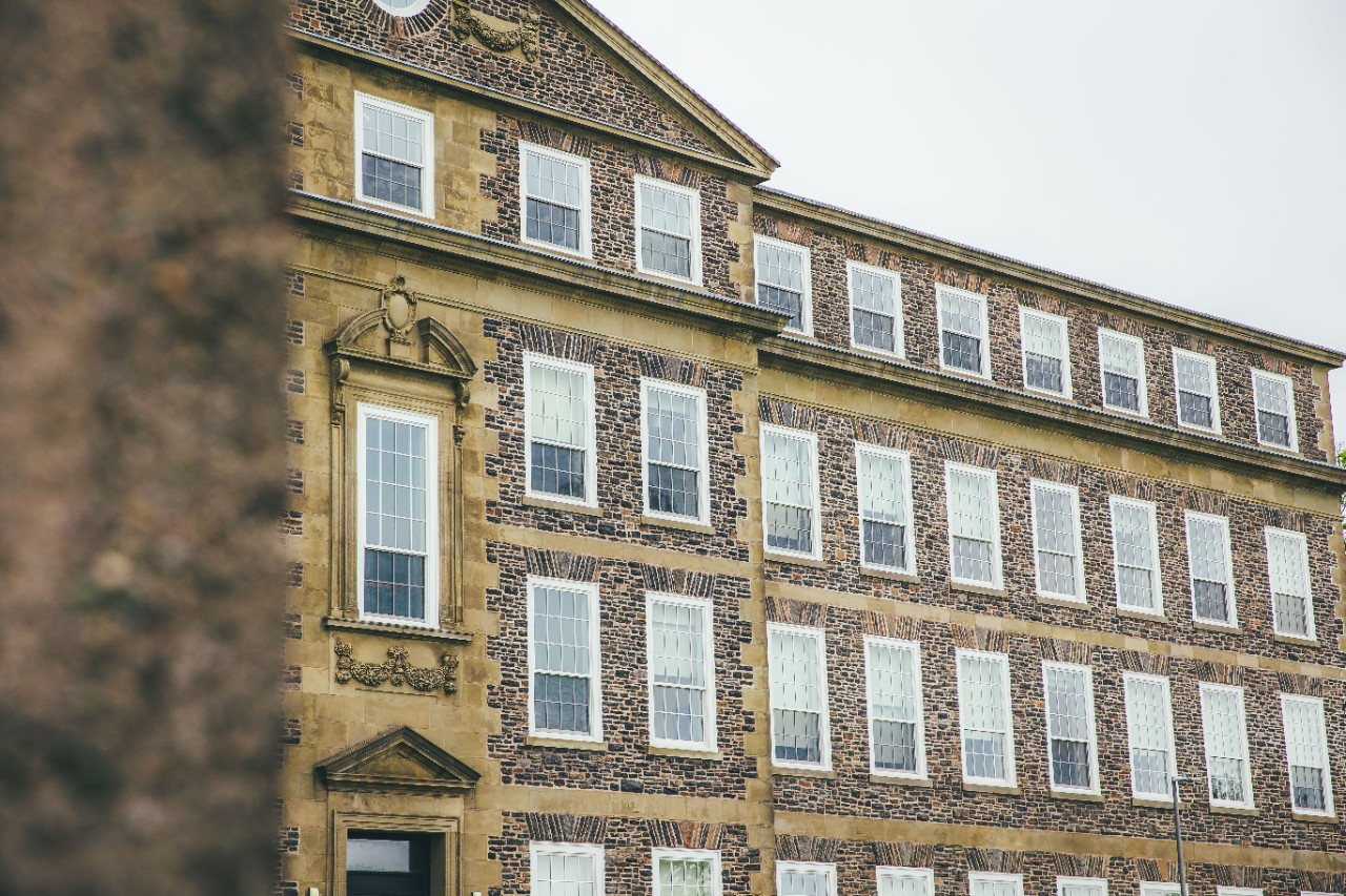 Exterior of Dalhousie's stone Henry Hicks building on a grey day.