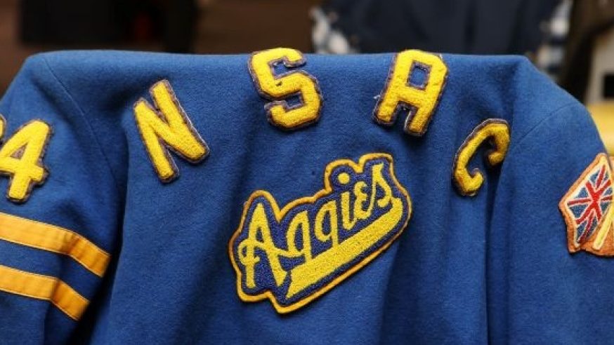 a blue sports jacket across the back of a chair with NSAC Aggies in yellow