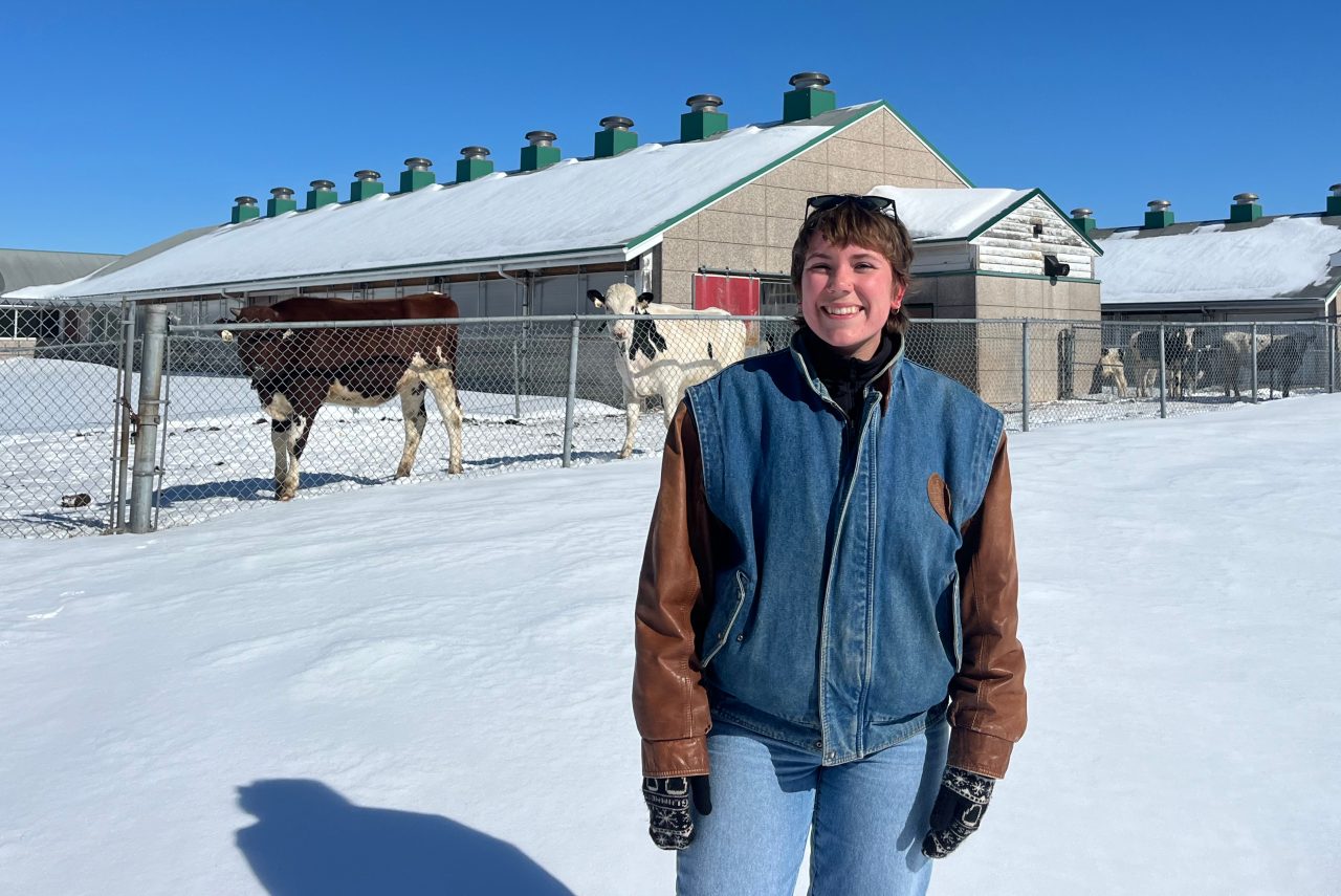Sophie Cramm standing in front of the Ruminant Animal Centre at Dalhousie Agricultural Campus
