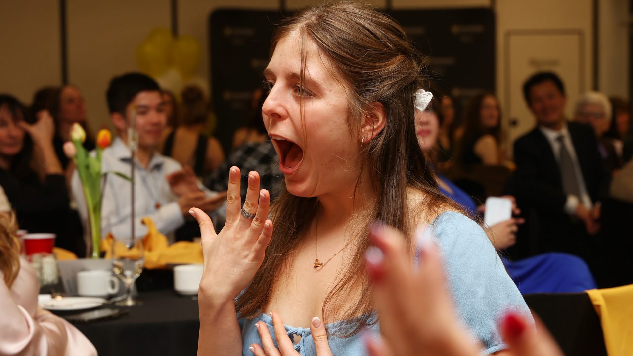 A student excited about receiving their barley ring