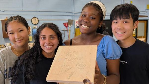 students posing with their homemmade birdhouse