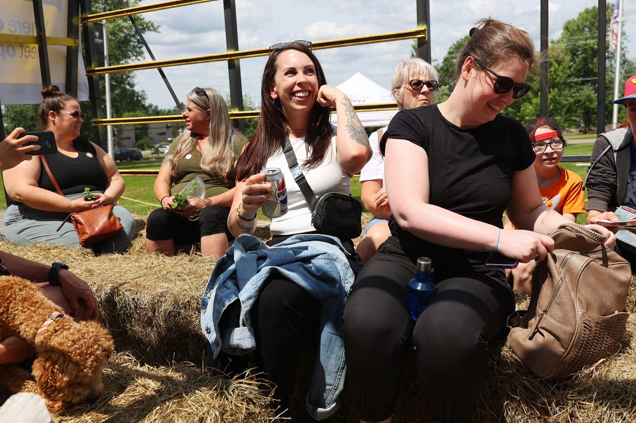 people taking a ride on haybales in a wagon on Community Day