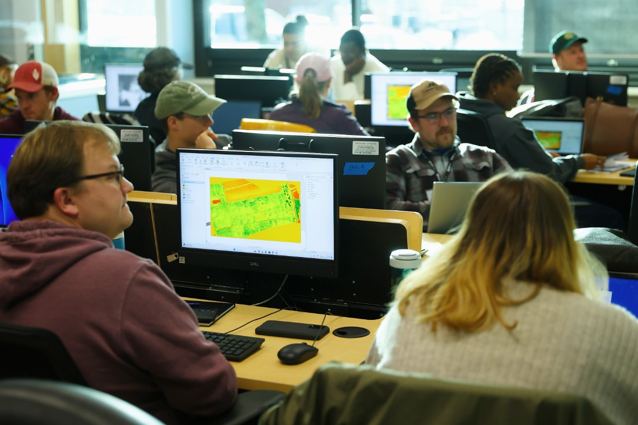 Students working at computers at various desks
