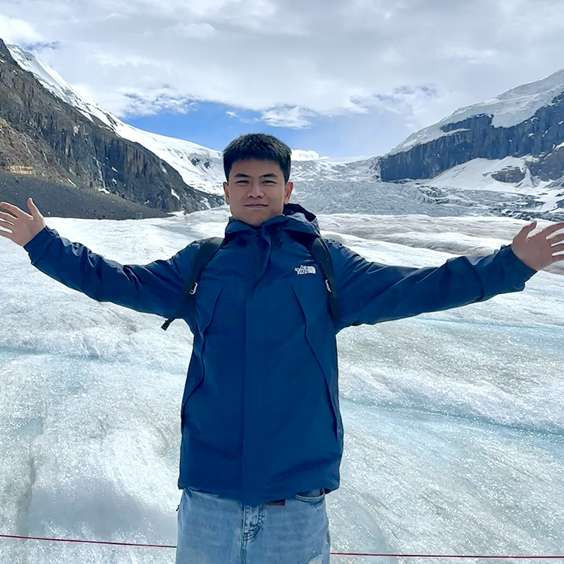 kai zhou posing on a glacier
