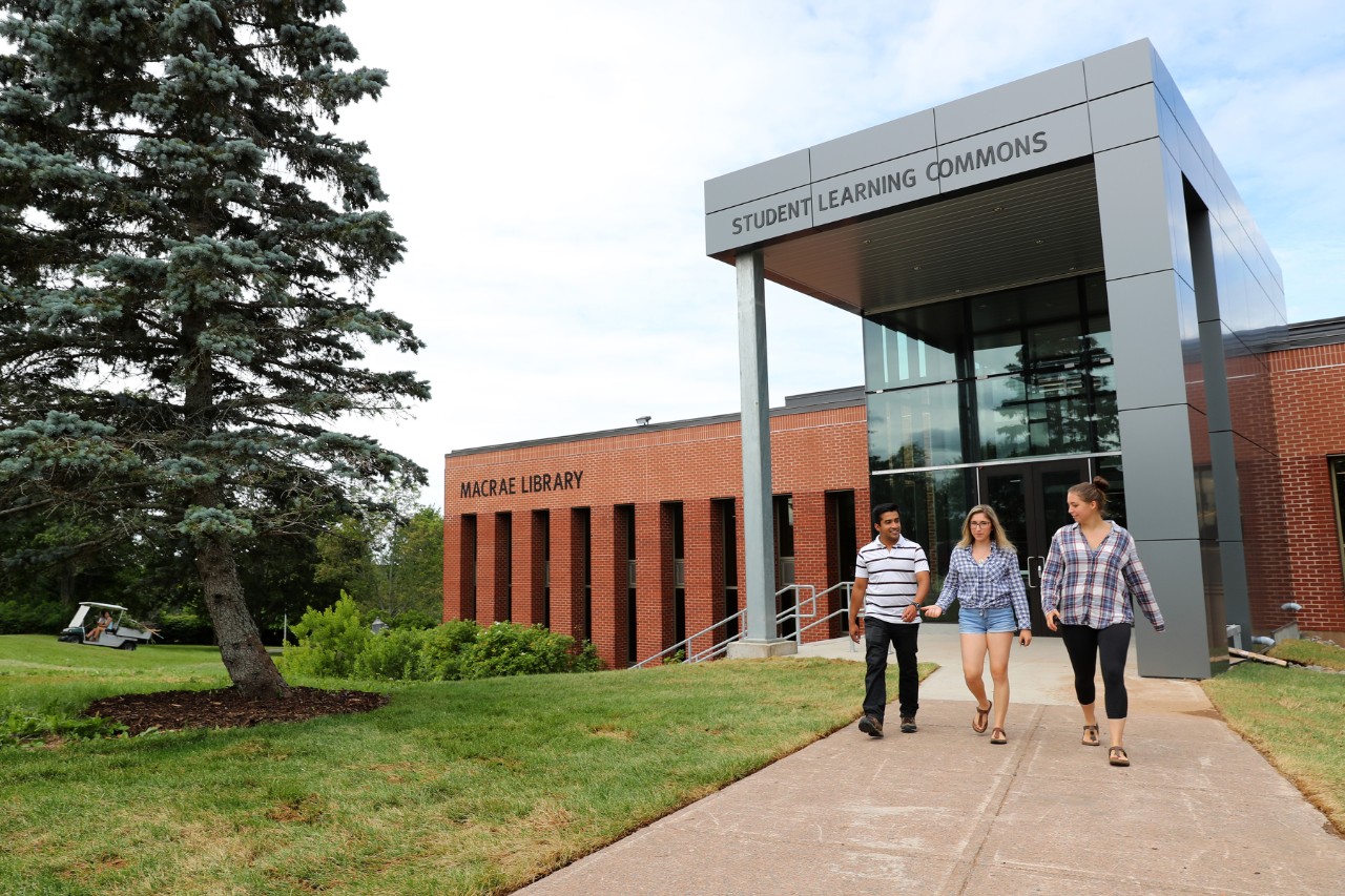 three students outside student learning commons in Truro