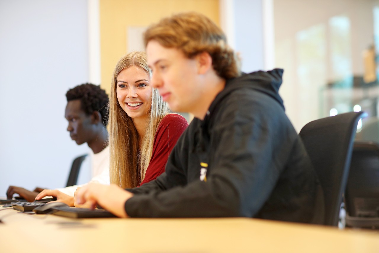 Three students at a desk
