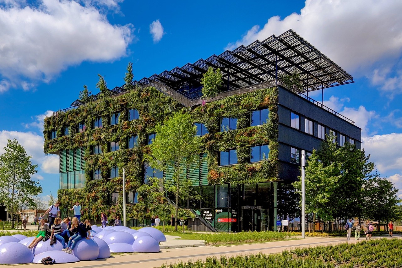 Modern building with greenery growing on the exterior walls.
