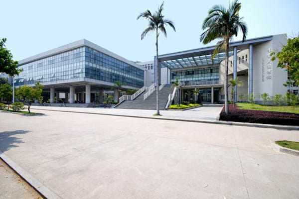 Modern concrete building with large glass windows.