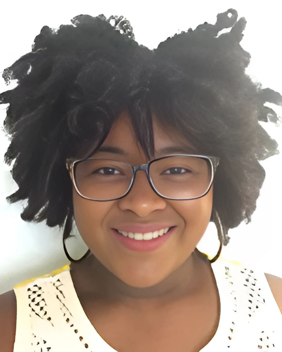 Close-up of smiling Black woman wearing glasses.
