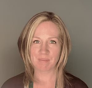 A headshot of a woman with short blonde hair.