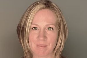 A headshot of a woman with short blonde hair.