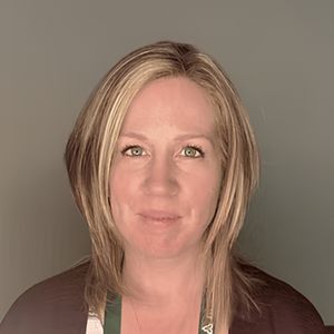 A headshot of a woman with short blonde hair.