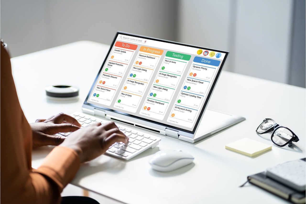 Person using management software on laptop