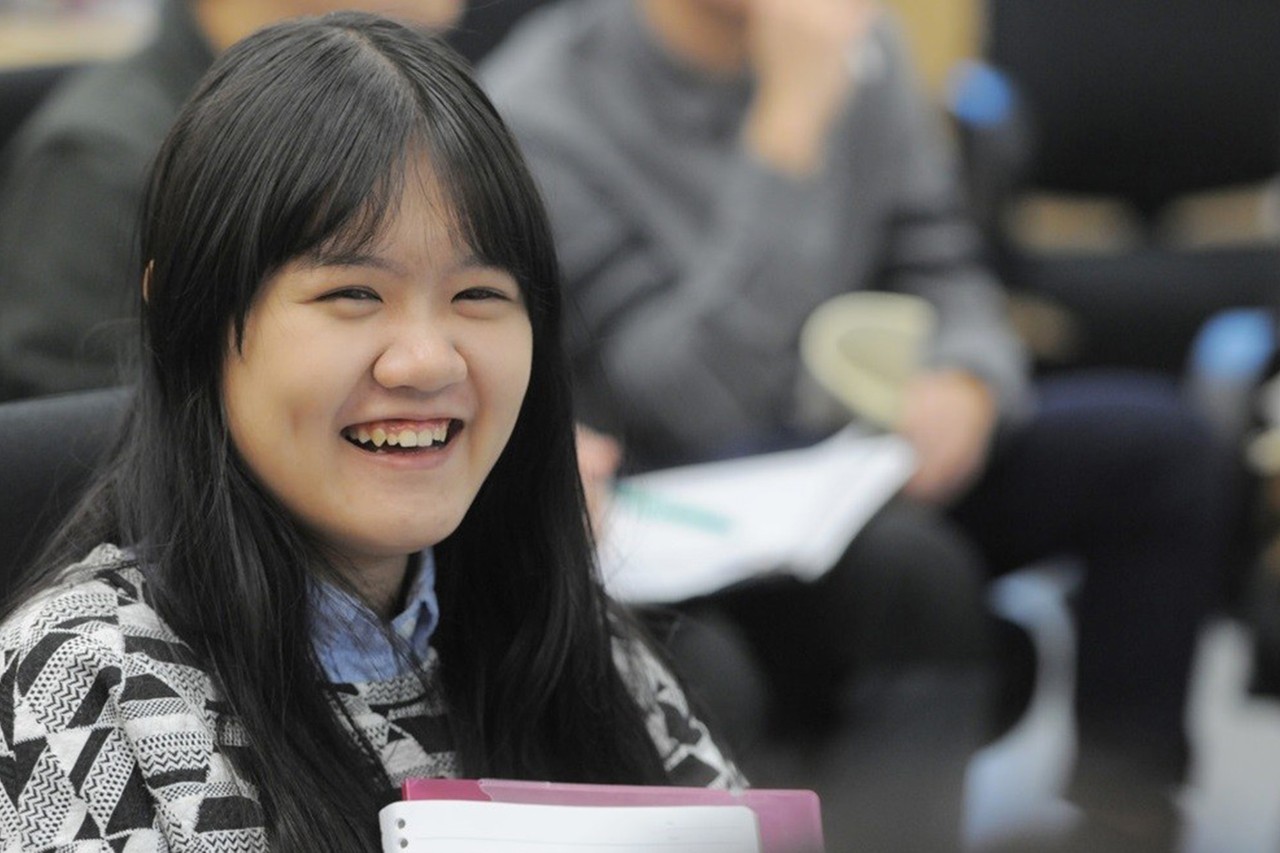 Student with long, dark hair sitting in classroom.