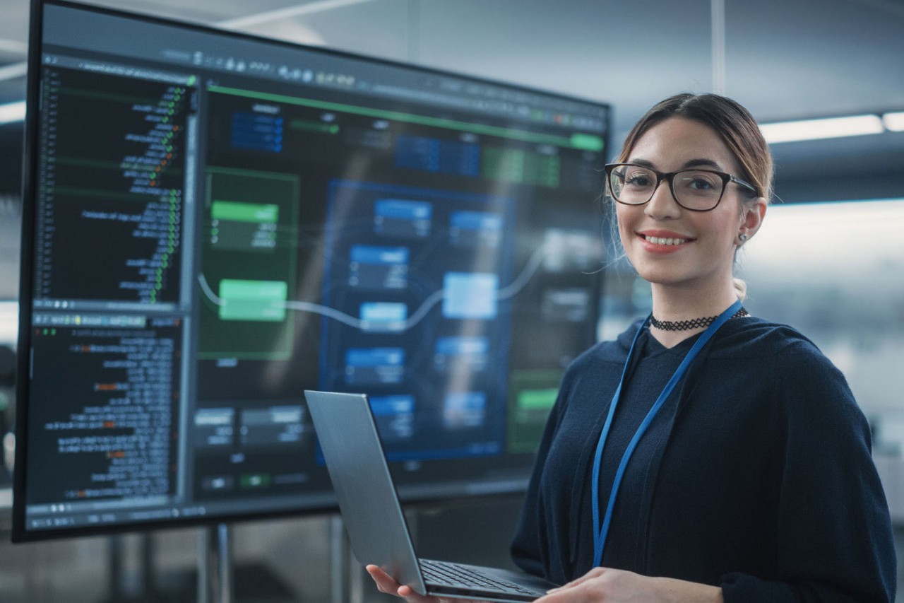 Portrait of a female wearing glasses, using a laptop 