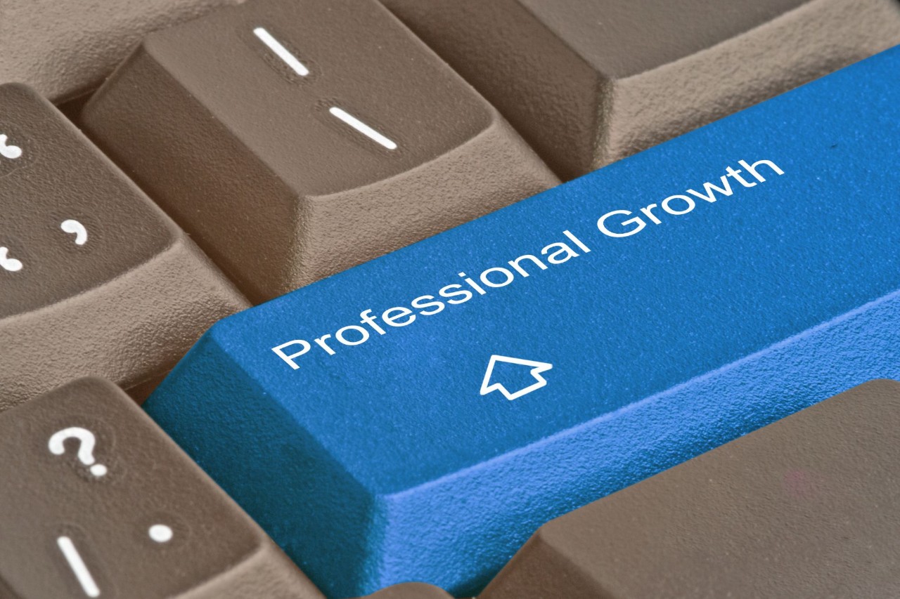 Blue button on a keyboard that says "Professional Growth