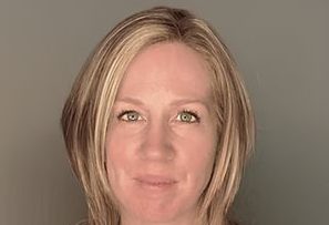 A headshot of a woman with short blonde hair.