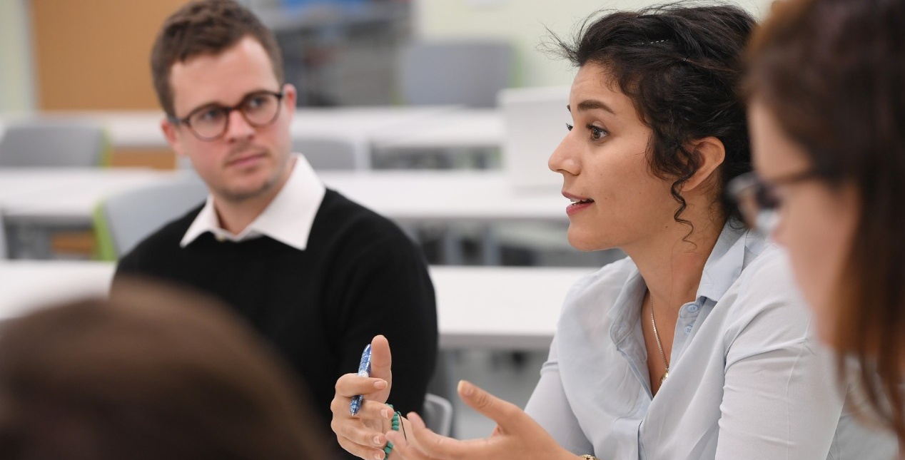 A teacher leading a small group of students in learning.