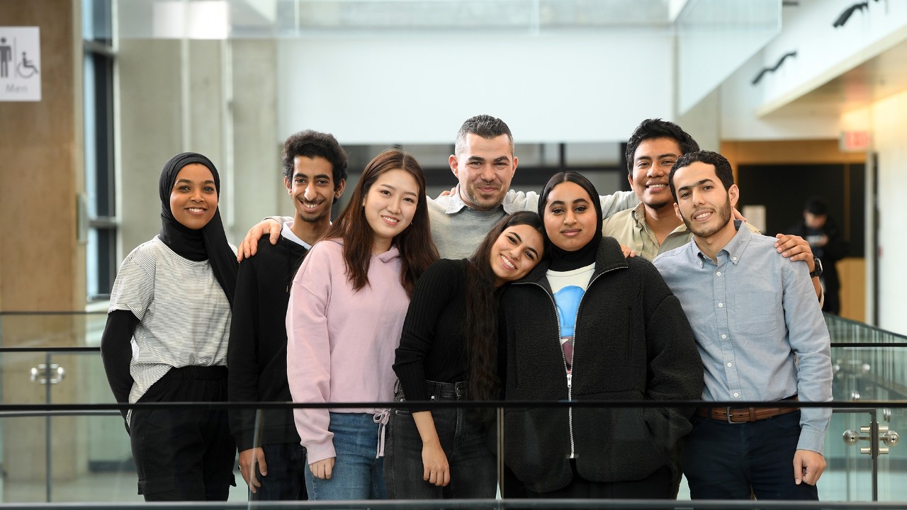 Group of English language studies students smiling.