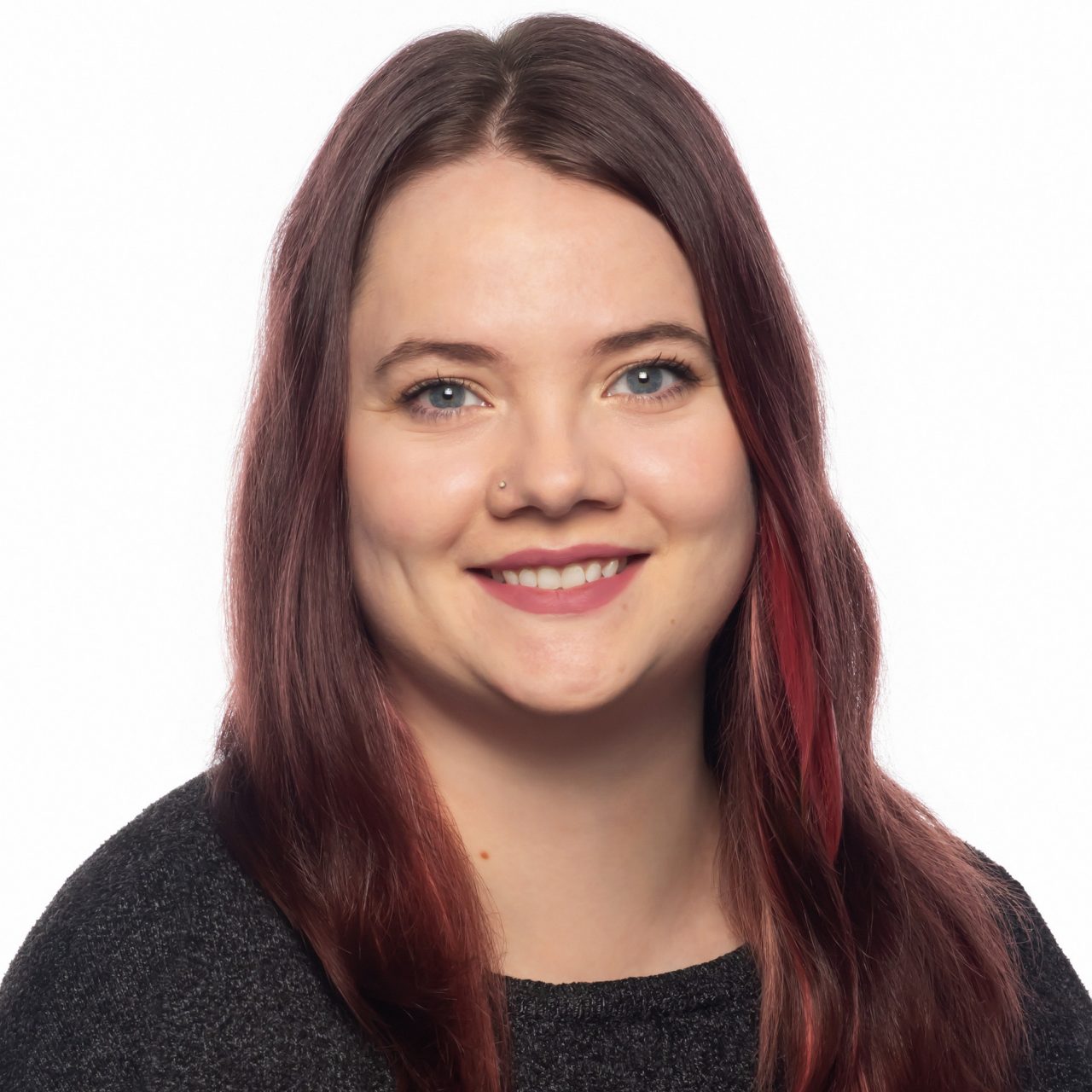 Elphege Bernard-Tran faces forward smiling wearing a black shirt in front of a white background 