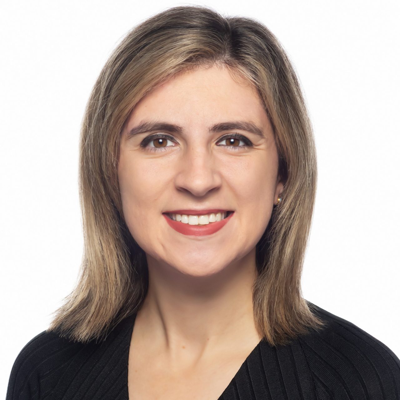 Nicole Kabalen faces forward smiling wearing a black shirt in front of a white background.