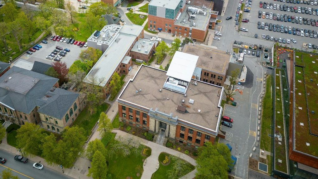 Aerial view of Dalhousie's downtown Sexton Campus with rooftops, green spaces and parking lots.