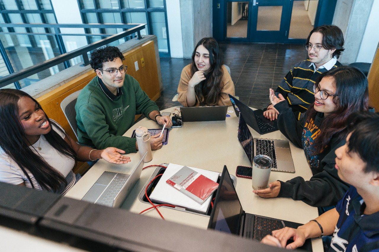 group of computer science students working together at a table