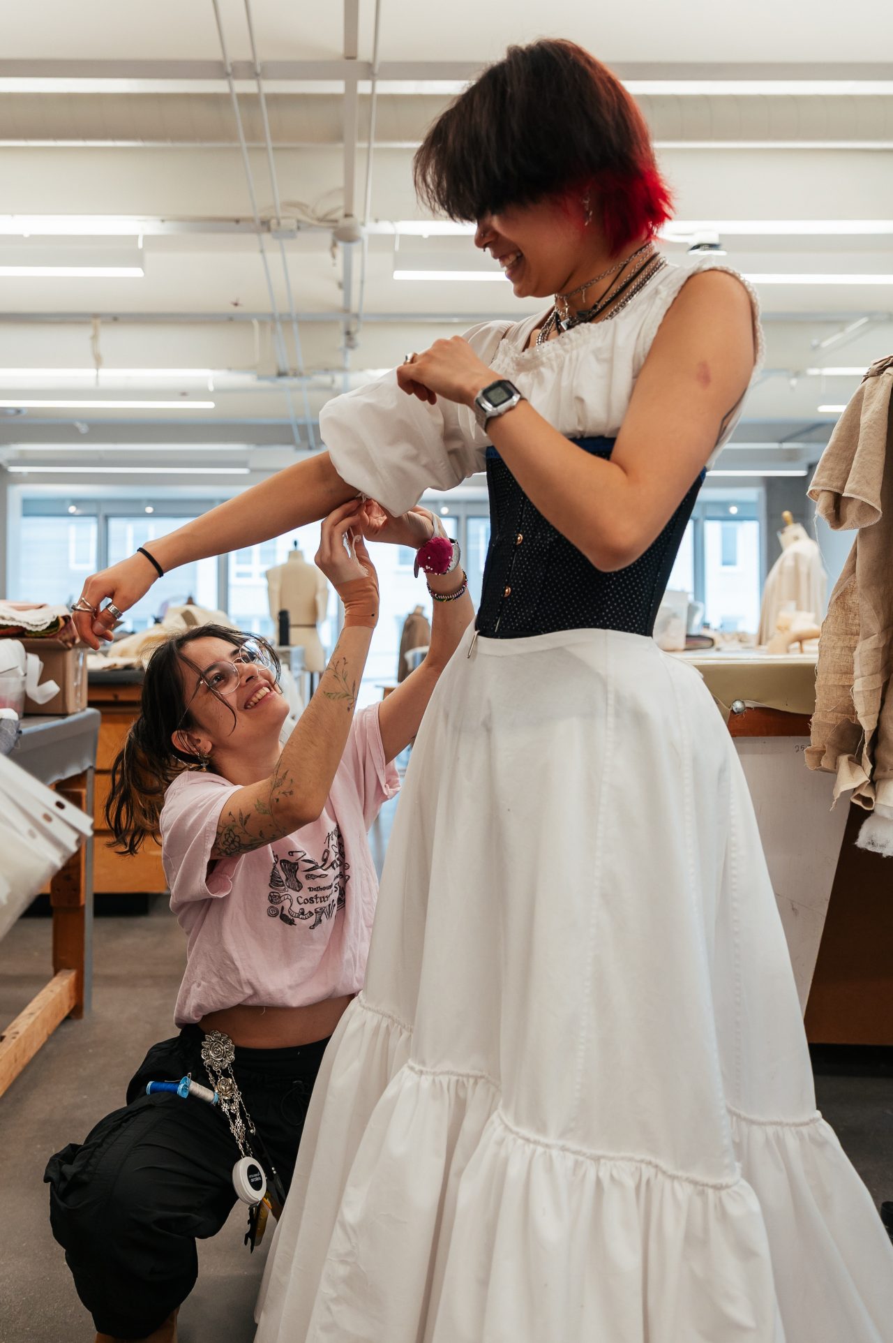 Two students working on a dress costume in the costume studio