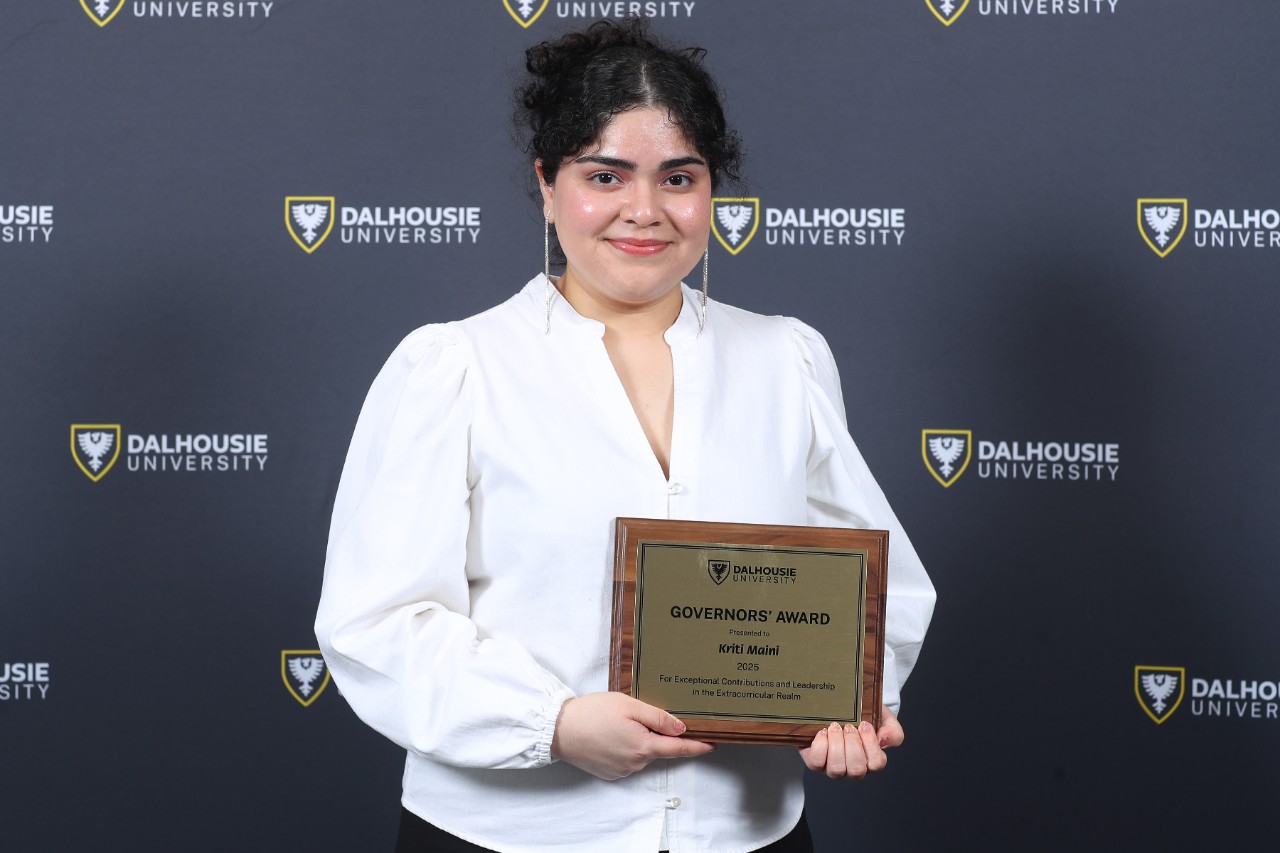 history graduate holding an award