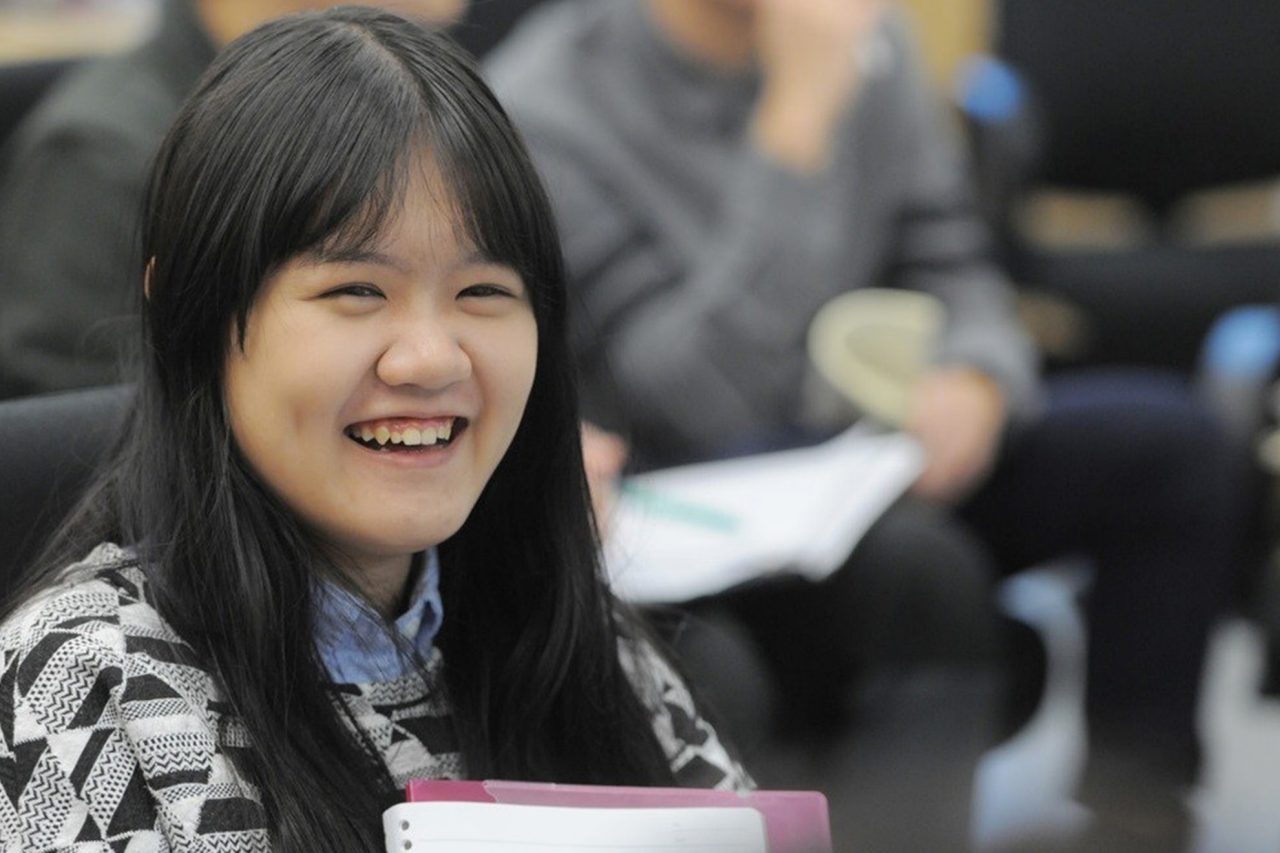Student with long, dark hair sitting in classroom.
